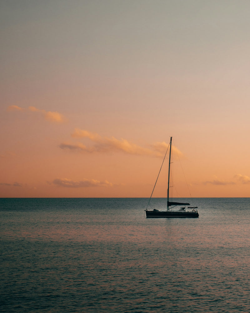 Yacht anchored at sea during sunset